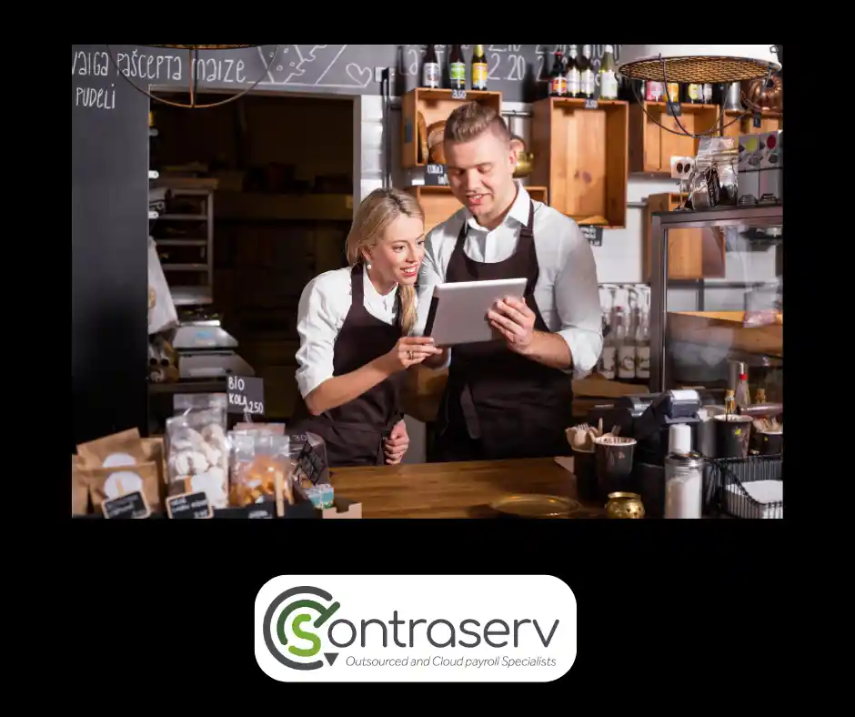PaySpace for Restaurants – Best Payroll Software – South Africa – Contraserv KZN Local Payroll Experts A lady and man standing in a restaurant kitchen and using a laptop. A restaurant owner and manager entering a new waiter's data onto their business's payroll software. PaySpace for Restaurants Best Payroll Software South Africa. Contraserv, KZN, SA.
